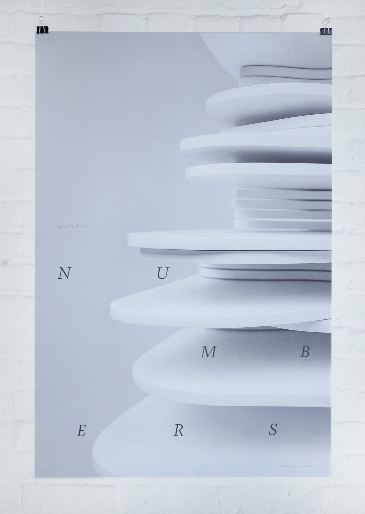 A poster design which has a close-up photo of the sculpture as the background, overlaid with "numbers" in all caps and arranged in a distorted 3x3 grid style