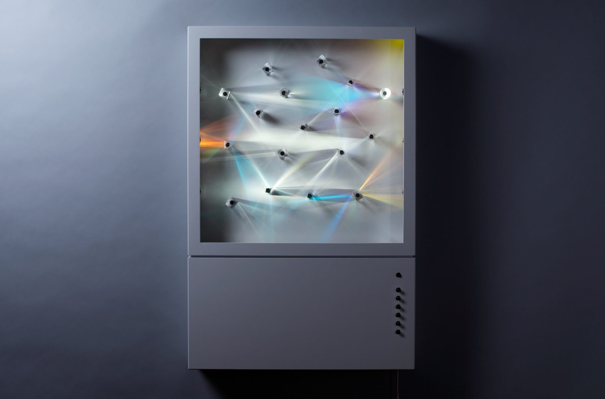 Straight on view of case with different prisms refracting light
