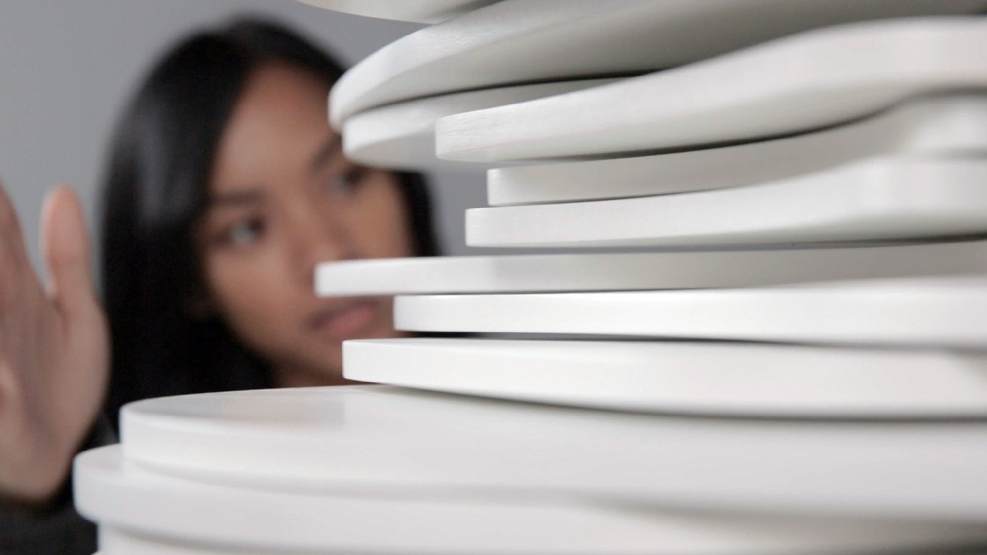 Young woman interacting with the sculptural piece