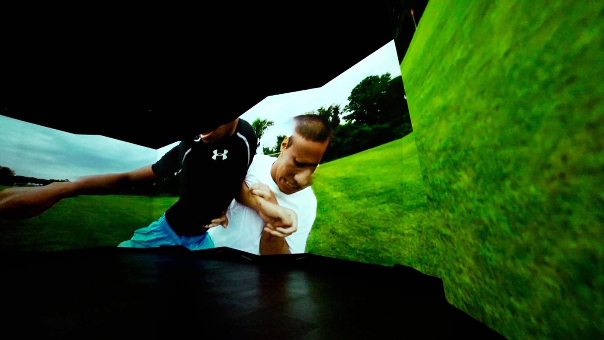 Close-up of two athletes competing on a field on the horizontal screen