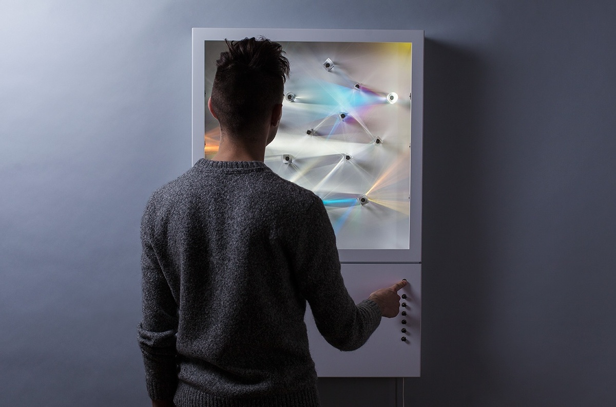 A guest interacting with the audiovisual installation by pressing on the buttons on the device that change the light patterns that are emitted