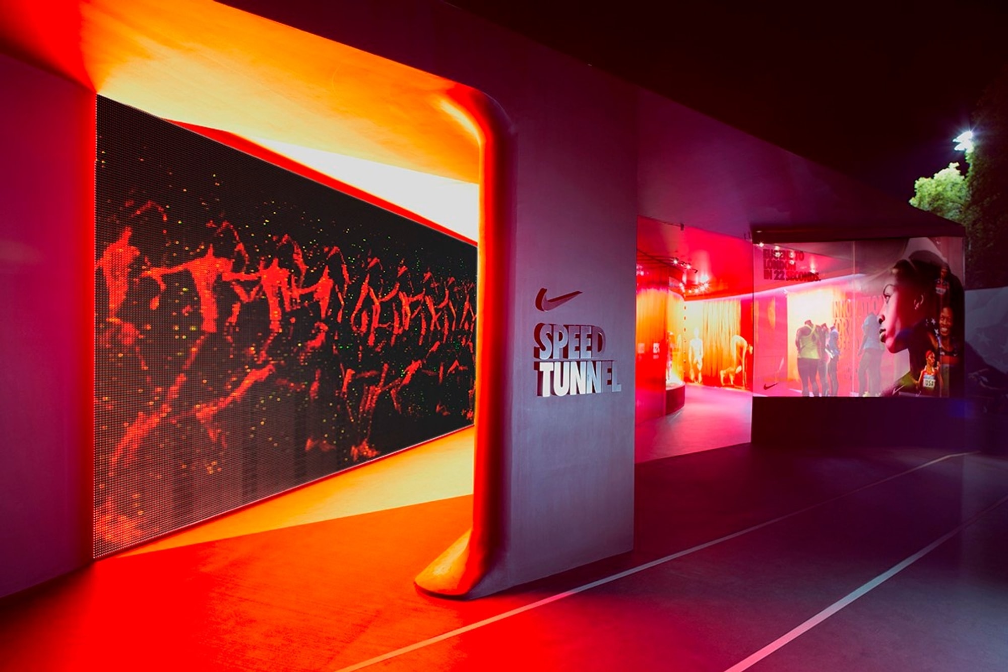 View from exterior of installation, with imagery of runners and text that reads "Speed Tunnel"