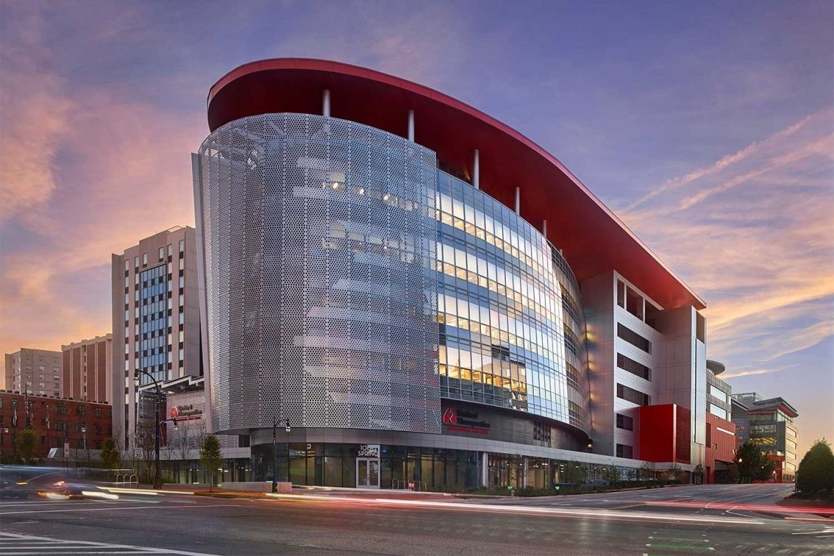 Exterior shot of building with glass facade and red roof