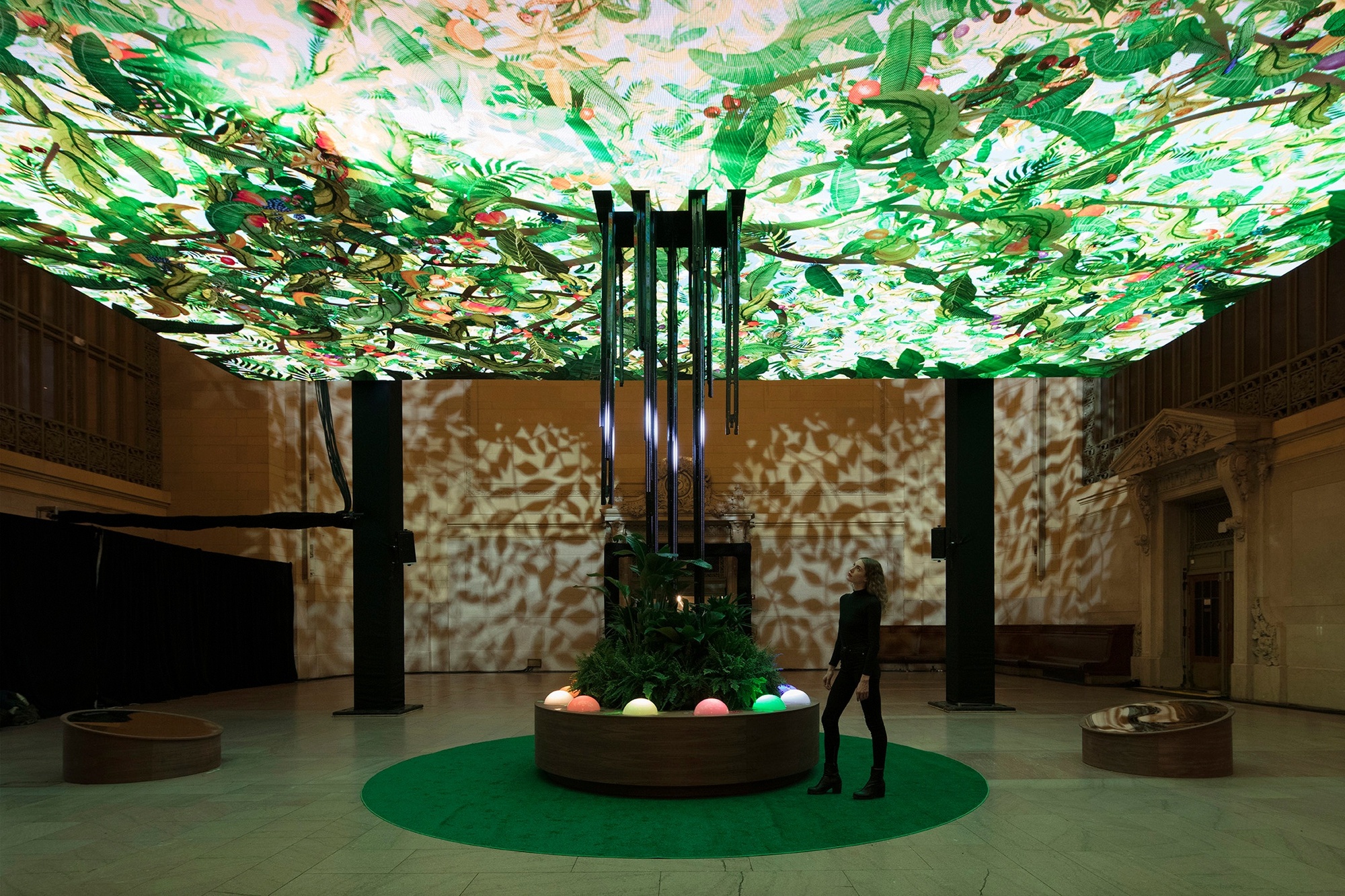 Photograph of person looking up at Chobani Giving Tree activation in Grand Central station