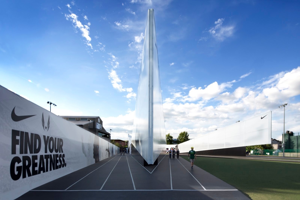 Photograph of outdoor track at Camp Victory, at one end of an angular architectural structure 